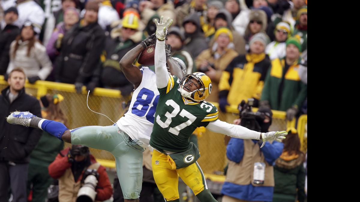 
Cowboys receiver Dez Bryant (88) catches a pass over Packers cornerback Sam Shields (37), though the play eventually was overturned on replay.
