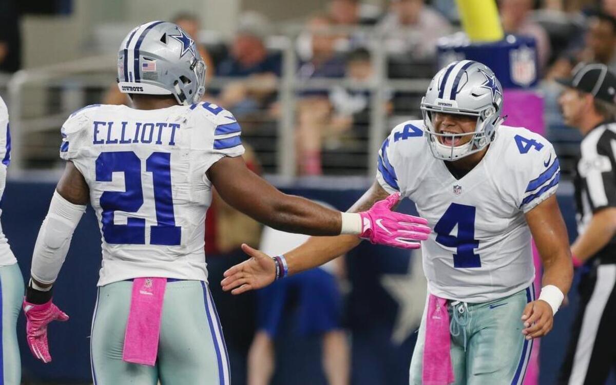 Dallas Cowboys running back Ezekiel Elliott (21) congratulates quarterback Dak Prescott (4) after scoring a touchdown against Cincinnati on Sunday. Together, the rookies have the Cowboys humming along to a division lead and 4-1 start to the season.