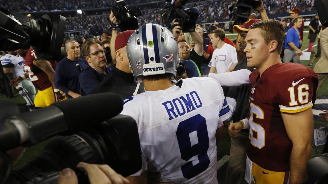 Dallas Cowboys quarterback Tony Romo (9) and Washington Redskins quarterback Colt McCoy (16) talk after the game as the Washington Redskins beat the Dallas Cowboys 20-17 in AT&T Stadium in Arlington, Texas, Monday October 27, 2014.