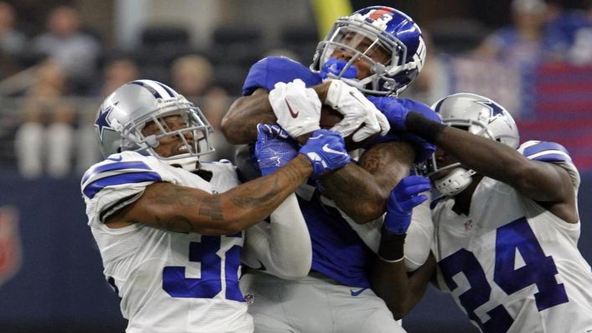 Odell Beckham had four catches for 73 yards against Orlando Scandrick, left, Morris Claiborne and Dallas.