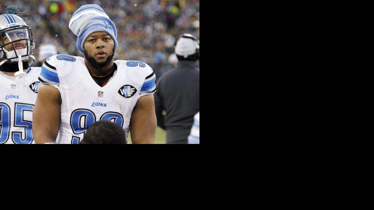 
Detroit Lions' Ndamukong Suh looks on during the first half of an NFL football game against the Green Bay Packers in Green Bay, Wis., on Sunday. The league announced Monday that Suh was suspended for the playoff game against the Cowboys for stepping on Packers quarterback Aaron Rodgers' left leg twice, once with each foot. Suh also applied pressure and pushed off Rodgers' unprotected leg with his left foot, violating unnecessary roughness rules, the league said in a statement. 

