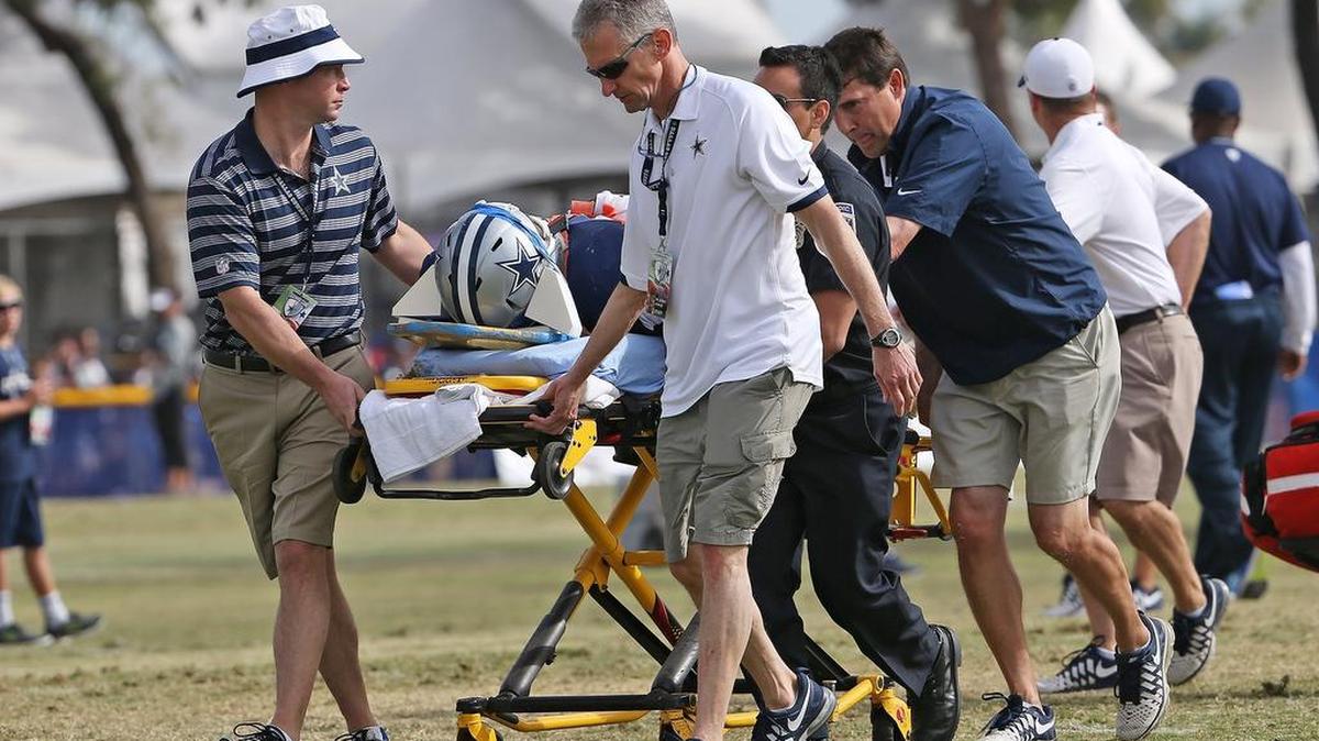 
Cowboys and medical personnel wheel defensive end Kenneth Boatright, strapped to a backboard, to a ambulance after he was injured in practice Thursday.
