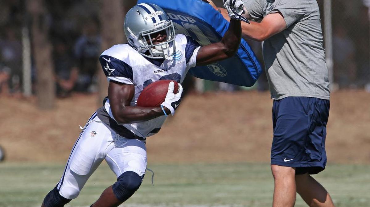 
Dallas Cowboys wide receiver Lucky Whitehead (13) hits a blocking pad during Saturday’s practice.
