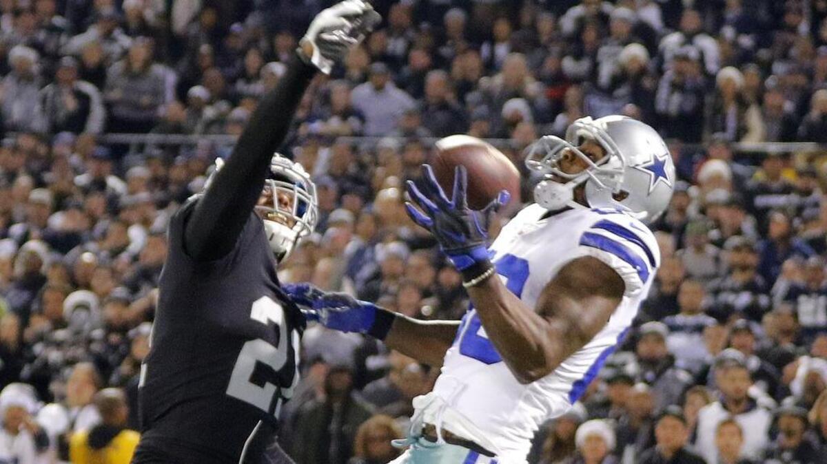 Dallas Cowboys wide receiver Dez Bryant (88) makes a one-handed catch for 40 yards with Oakland Raiders cornerback Sean Smith (21) defending as the Dallas Cowboys beat the Oakland Raiders 20-17 at Oakland-Alameda County Coliseum in Oakland, California, Sunday, December 17, 2017.