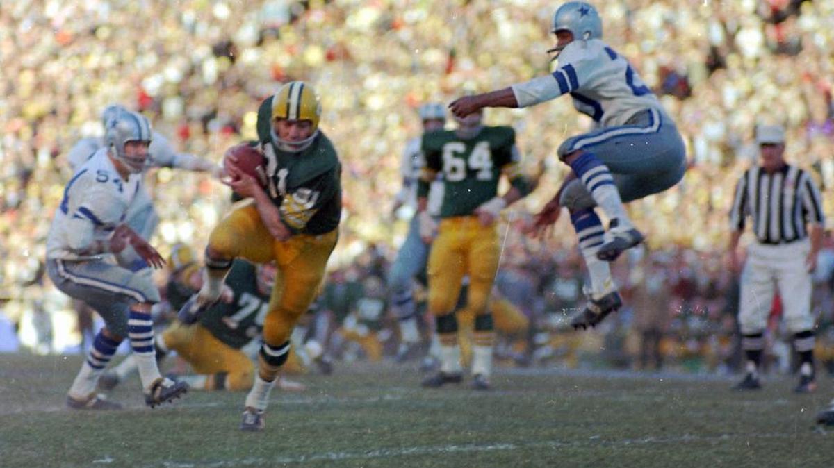 Green Bay Packers Jim Taylor runs with a Bart Starr pass as Dallas Cowboys Mel Renfro (20) leaps high in air too late to break up the pass during the NFL Championship game, Jan. 1, 1967 in Dallas, Tx. At left is Cowboys Chuck Howley (54). The Packers defeated the Cowboys 34-27.