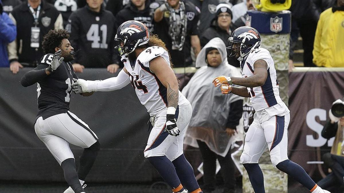 Oakland Raiders wide receiver Michael Crabtree, left, fights with Denver Broncos nose tackle Domata Peko, center, and cornerback Aqib Talib during the first half of of a game in Oakland on Sunday. Crabtree, Talib and Gabe Jackson were ejected.
