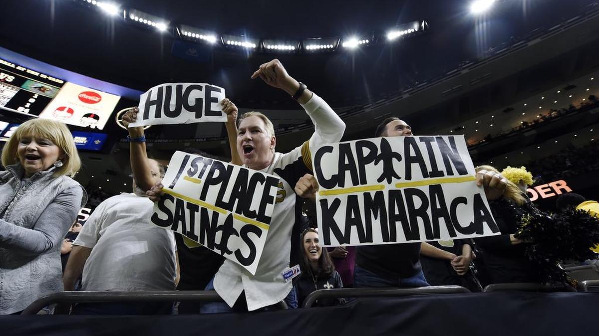New Orleans Saints fans hold signs and cheer after the Saints beatthe Carolina Panthers 31-21 in New Orleans on Dec. 3.