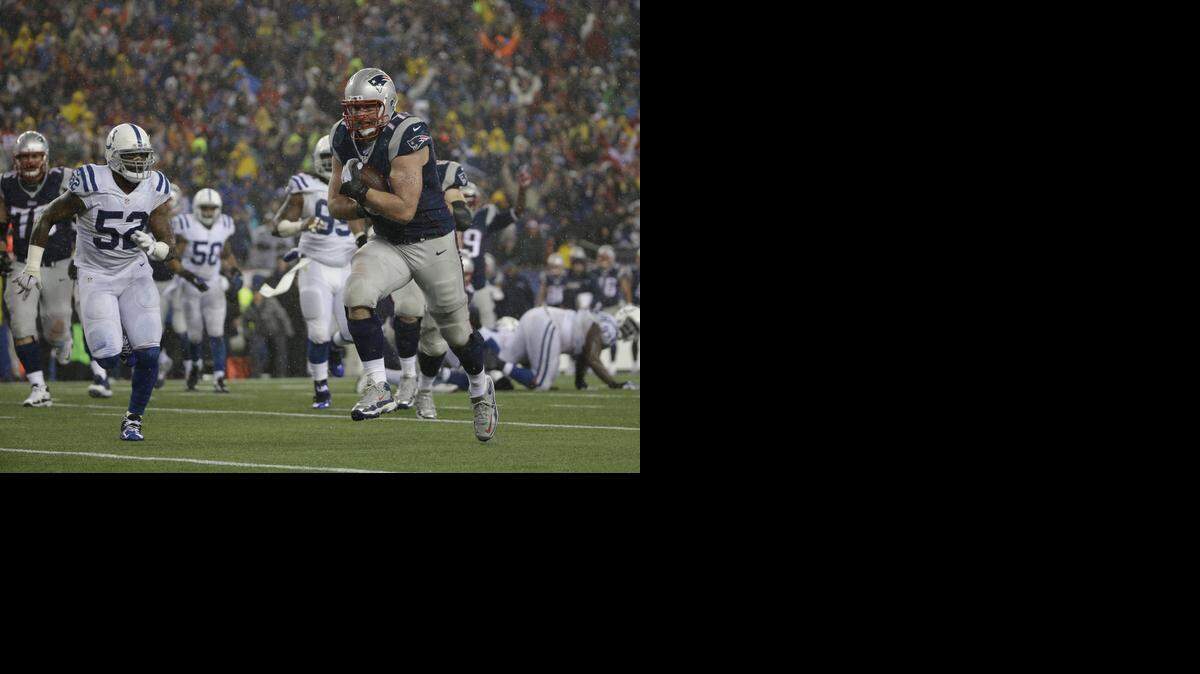 
New England Patriots tackle Nate Solder (77) makes a touchdown reception  against the Indianapolis Colts in the AFC Championship Game. Solder lined up as an eligible receiver. Hand signals will let the defense know who’s an eligible receiver and who’s not in the Super Bowl. 
