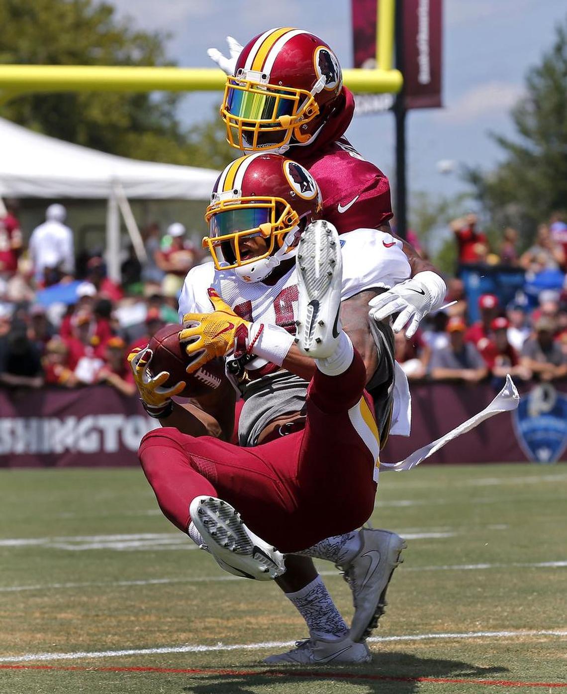 Washington Redskins receiver Josh Doctson (18) pulls in a reception against Bashaud Breeland (26) during football training camp in Richmond, Va., Saturday, Aug. 5, 2017.