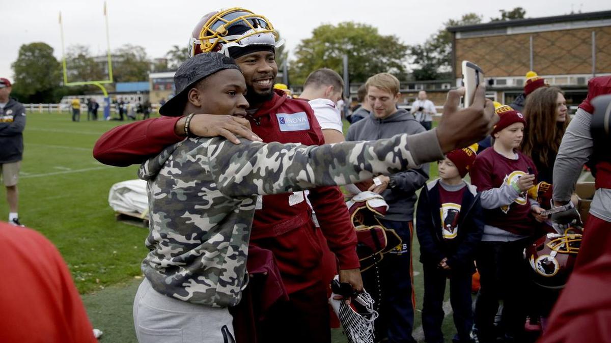 Washington Redskins cornerback Josh Norman, who is recovering from a concussion, took time from a practice session to pose for photographs with fans in west London. The Redskins play the Cincinnati Bengals on Sunday (8:30 a.m., KTVT/11) in the final NFL game this season in London.