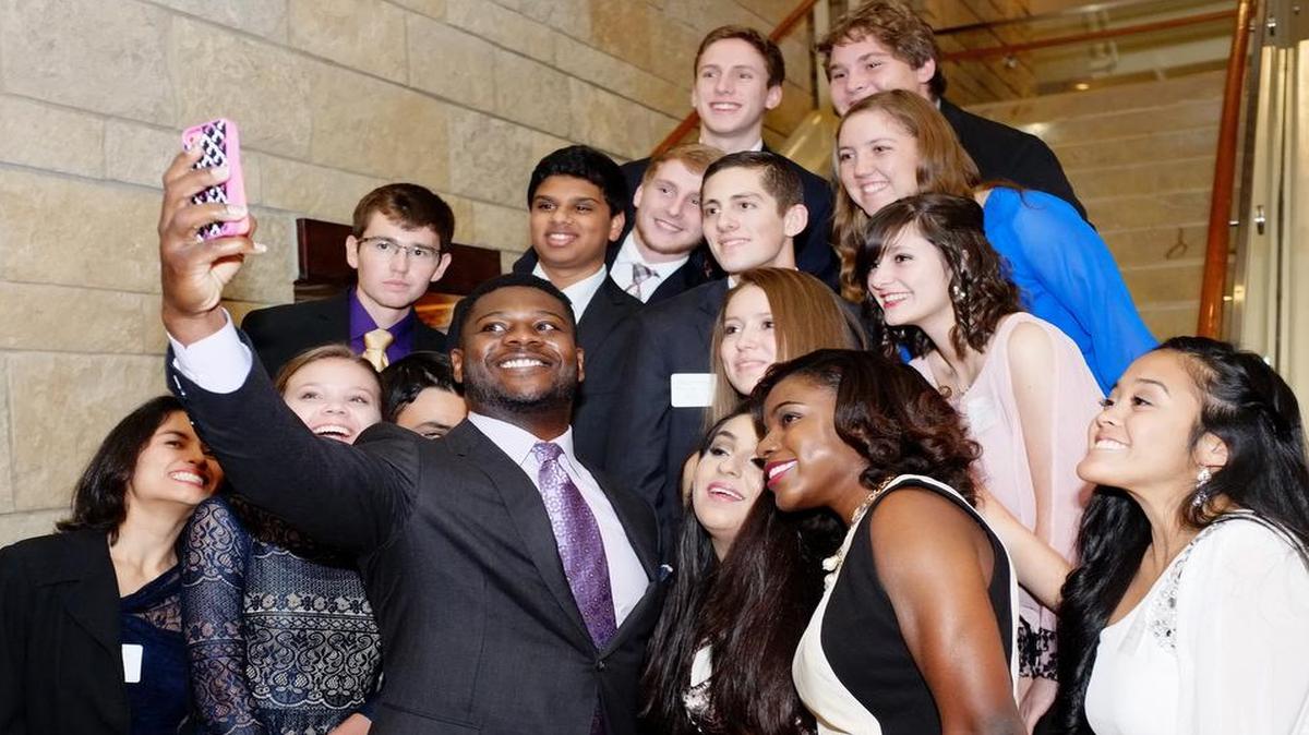 LaDainian Tomlinson takes a selfie with honorary high school seniors Wednesday at the Omni Fort Worth Hotel.