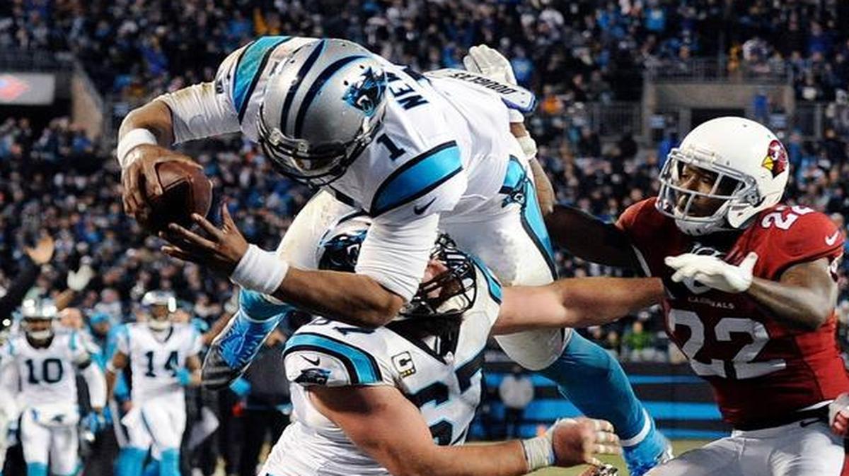 Carolina Panthers quarterback Cam Newton leaps into the end zone for a touchdown during the second half against the Arizona Cardinals Sunday in Charlotte, N.C.