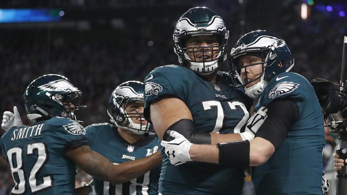 Eagles quarterback Nick Foles, right, celebrates his touchdown catch with former TCU lineman Halapoulivaati Vaitai during the first half of Super Bowl 52.