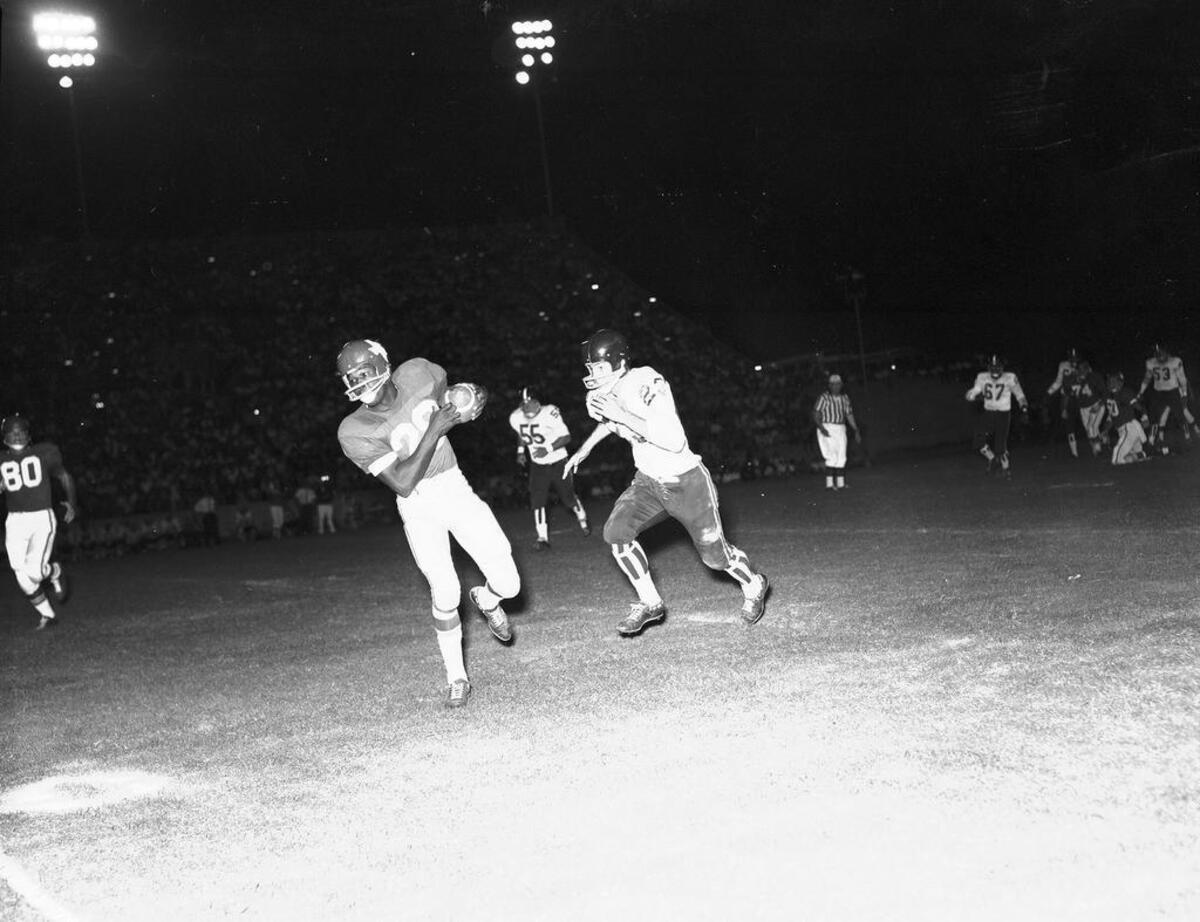 Dallas Texans running back Abner Haynes takes a pass from Hunter Enis during the exhibition game against Denver at Farrington Field in 1961.