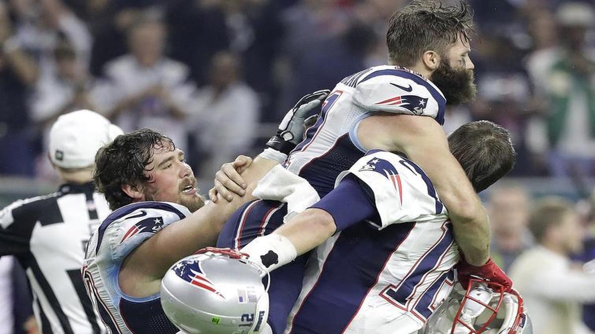 Tom Brady, right, hugs Julian Edelman as they celebrate the Patriots’ historic comeback victory over the Falcons in Super Bowl LI.