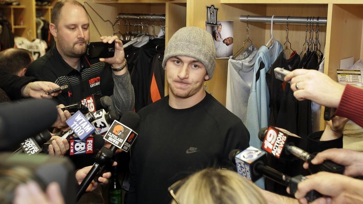Former Cleveland Browns quarterback Johnny Manziel talks with the media in December 2014.