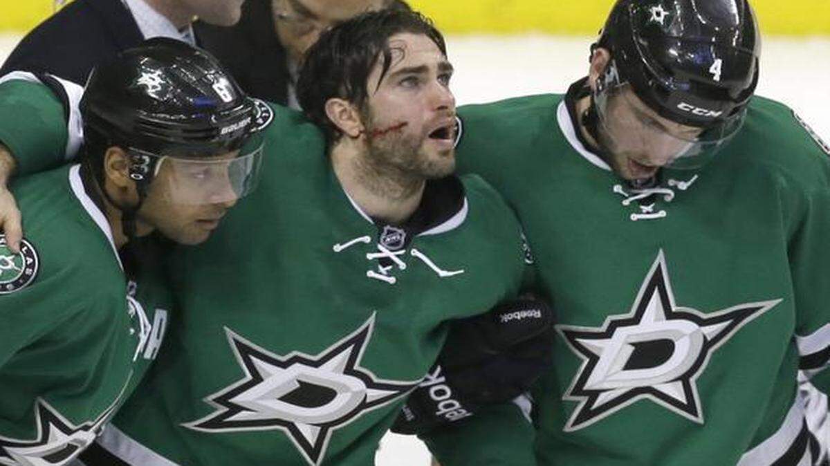 
Stars right wing Patrick Eaves, center, is helped off the ice by teammates Jason Demers, right, and Trevor Daley after Eaves was struck in the face by the puck during the third period.


