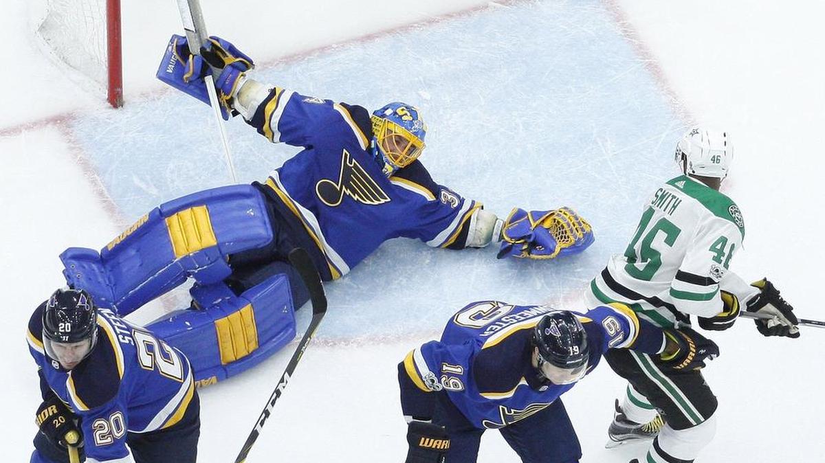 St. Louis Blues goalie Jake Allen, top left, falls while reaching for a puck as Dallas Stars’ Gemel Smith (46) watches during the first period.