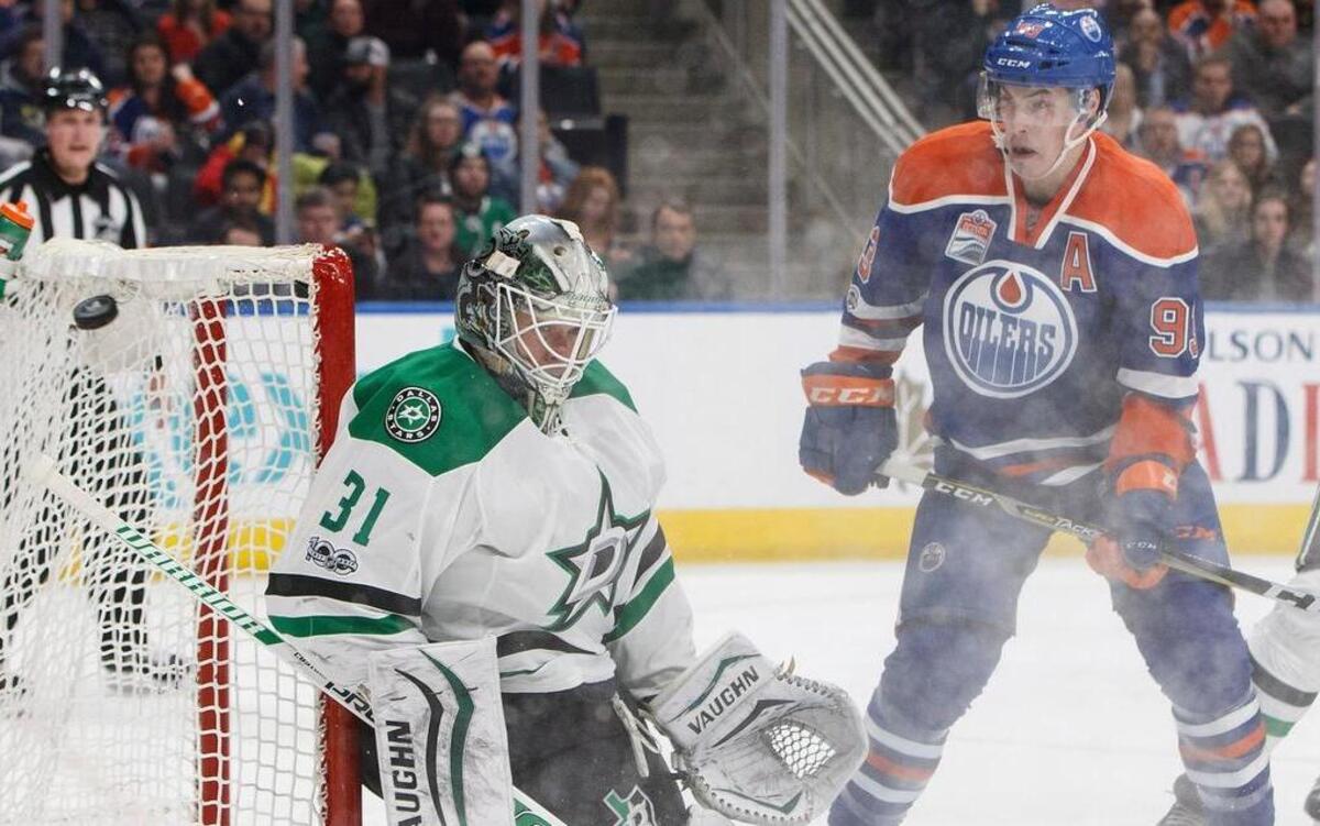 Stars goalie Antti Niemi (31) tries stopping a puck as Oilers' Ryan Nugent-Hopkins (93) looks for a rebound. The Stars lost Tuesday 7-1.