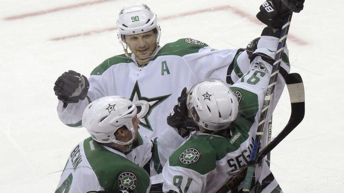 Stars center Tyler Seguin, right, celebrates his winning goal 20 seconds into overtime Sunday with teammates Jamie Benn, left, and Jason Spezza.