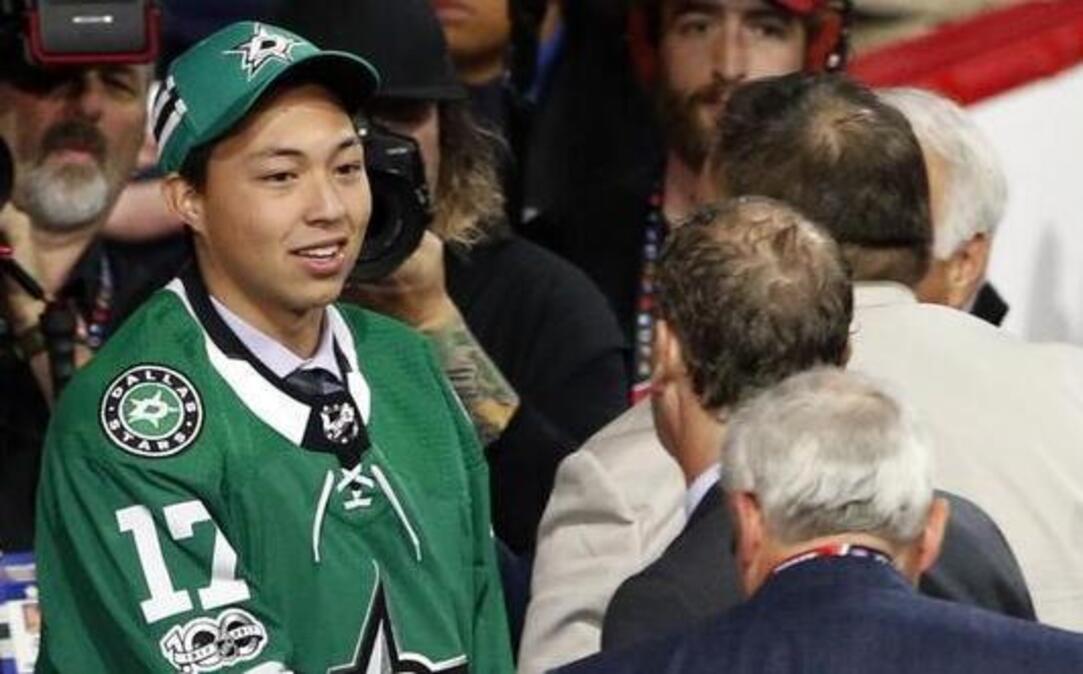 Jason Robertson, left, talks with representatives from the Dallas Stars after being selected in the second round of the NHL draft on Saturday in Chicago.