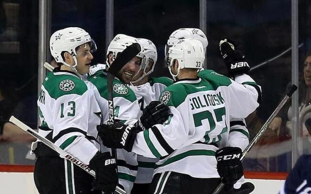 The Stars celebrate a goal by John Klingberg (3) as Winnipeg’s Bryan Little, right, skates past during the second period.