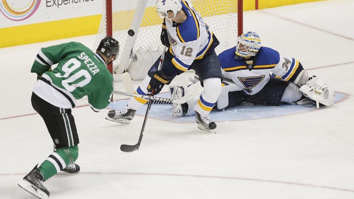 Stars forward Jason Spezza, left, shoots past Blues forward Jori Lehtera (12) and goalie Jake Allen (34) for his second goal of the game in the third period Saturday. Spezza has scored in six consecutive games and has 10 goals in the past 10 games.