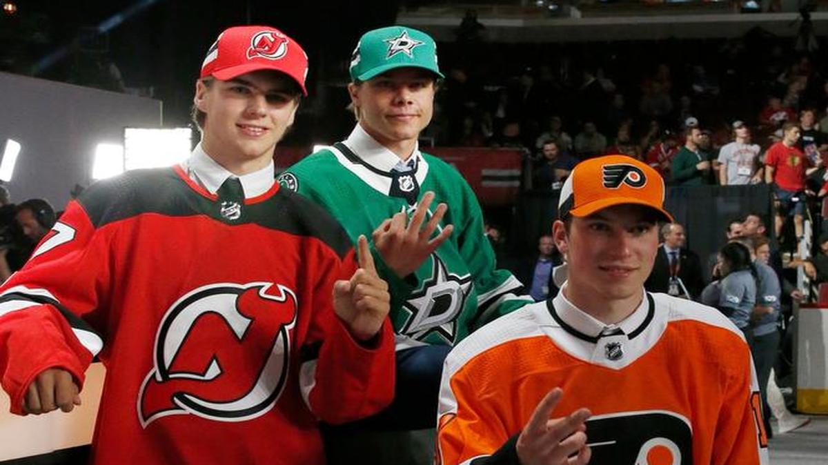 New Jersey Devils draft pick Nico Hischier, left, Dallas Stars pick Miro Heiskanen, center, and Philadelphia Flyers pick Nolan Patrick pose for photos after being selected during the first round of the NHL hockey draft, Friday, June 23, 2017, in Chicago.