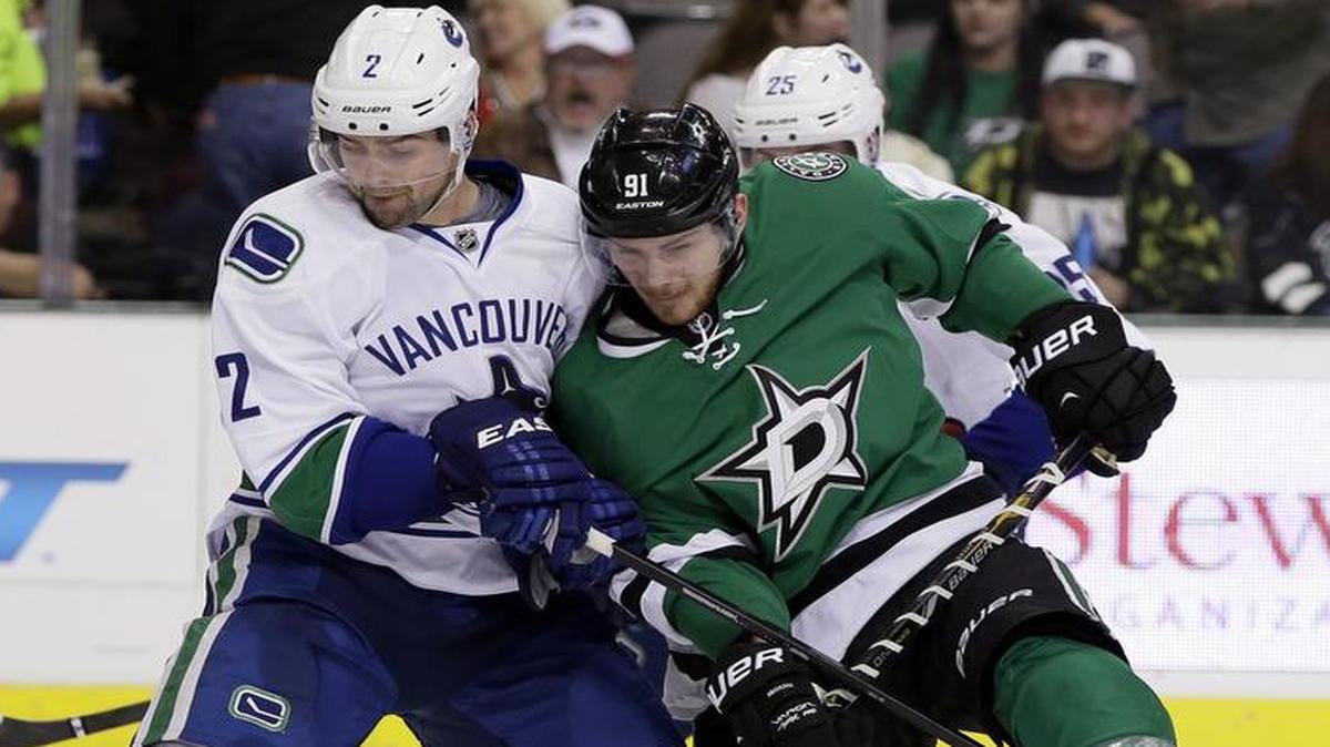 Vancouver Canucks defenseman Dan Hamhuis (2) strips the puck away from Dallas Stars center Tyler Seguin (91) during a game in Dallas in 2013. Hamhuis will join the Stars this season after signing a two-year deal in the opening hours of free agency Friday afternoon.