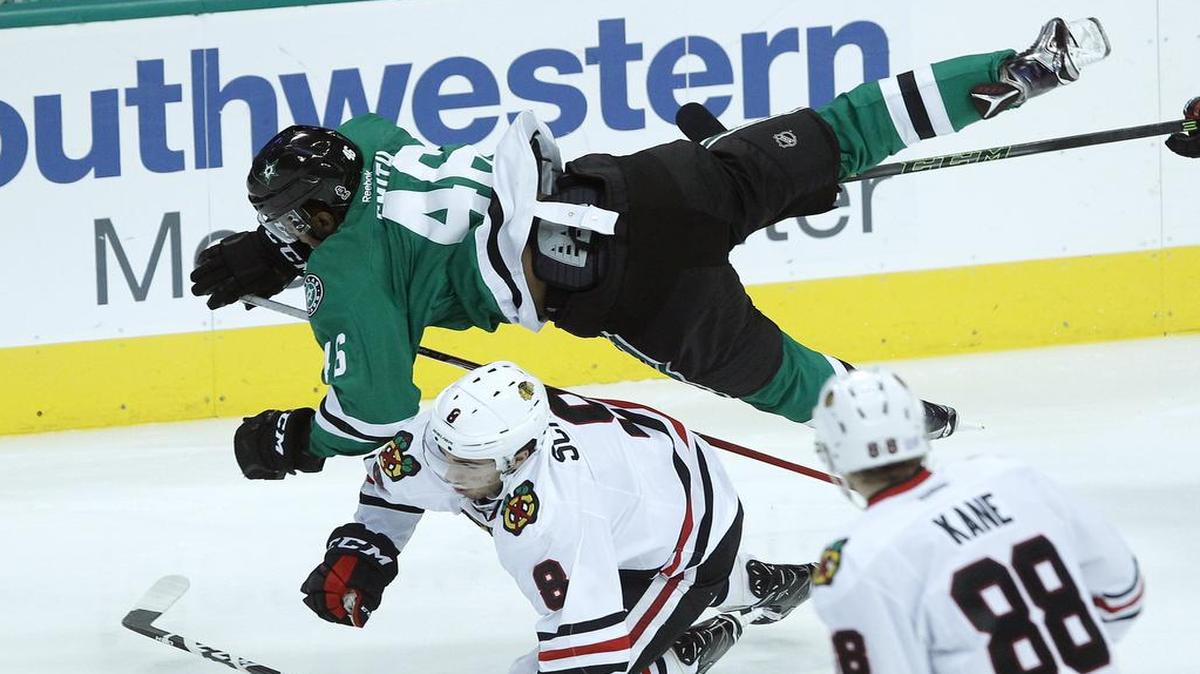 Stars center Gemel Smith is upended by Blackhawks center Nick Schmaltz in the third period on Saturday in Dallas. Chicago won 3-2.