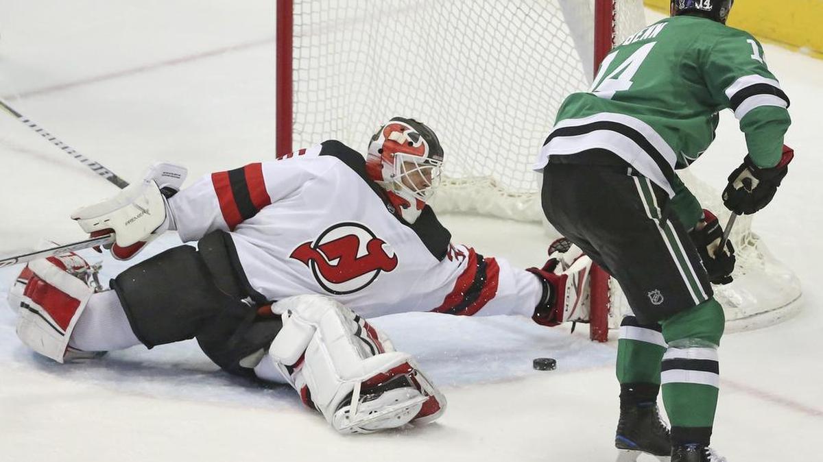 New Jersey Devils goaltender Cory Schneider (35) gives up a goal to Dallas Stars’ Tyler Seguin, not seen, as Stars left wing Jamie Benn (14) skates past the .