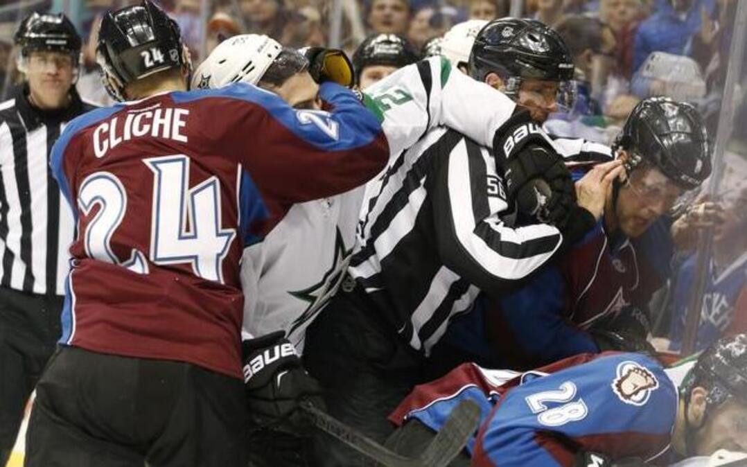 
Colorado Avalanche center Marc-Andre Cliche restrains Dallas Stars center Colton Sceviour as linesman Mark Wheeler pushes away Avalanche defenseman Jan Hejda, of the Czech Repoublic, during a scrum behind the Stars' net in the third period of an NHL hockey game Saturday, Feb. 14, 2015, in Denver. Colorado won 4-1. 
