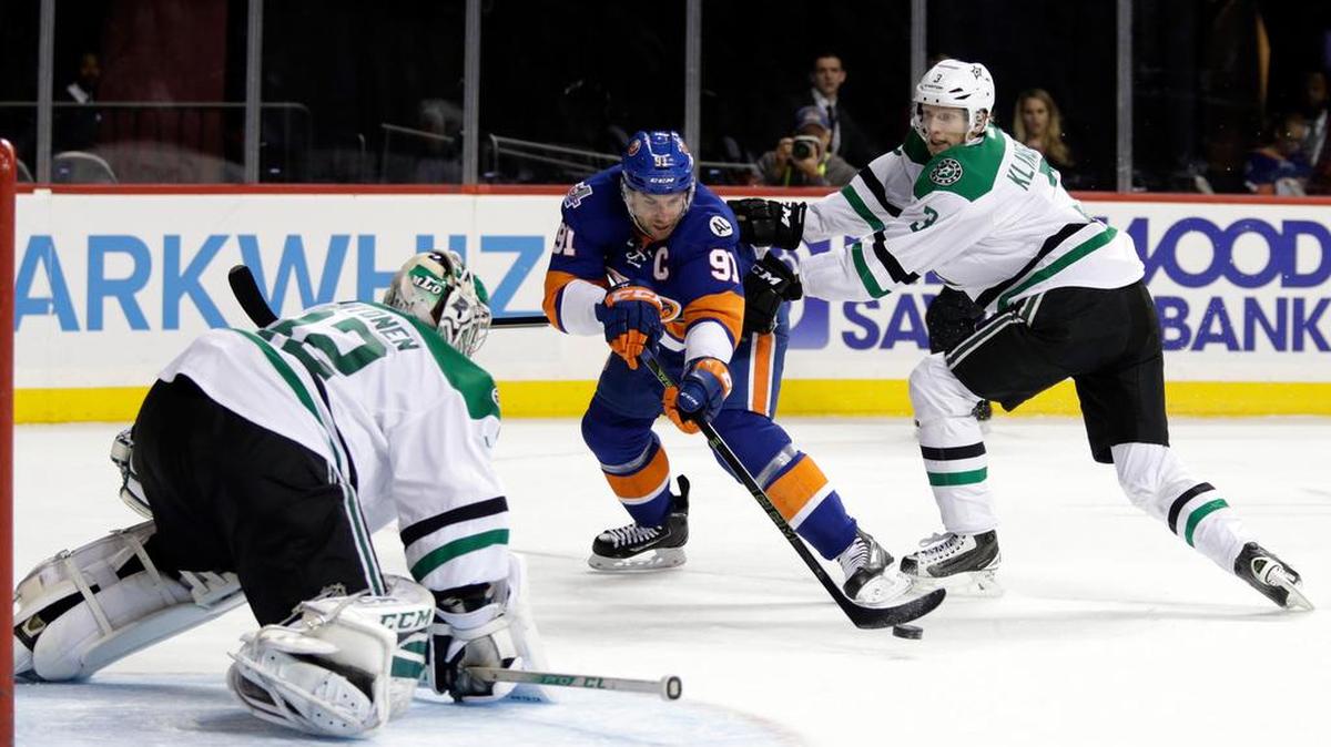 New York Islanders center John Tavares (91) takes a shot on Dallas Stars goalie Kari Lehtonen while being defended by Stars defenseman John Klingberg (3) in the second period of an NHL hockey game, Sunday, Jan. 3, 2016, in New York.