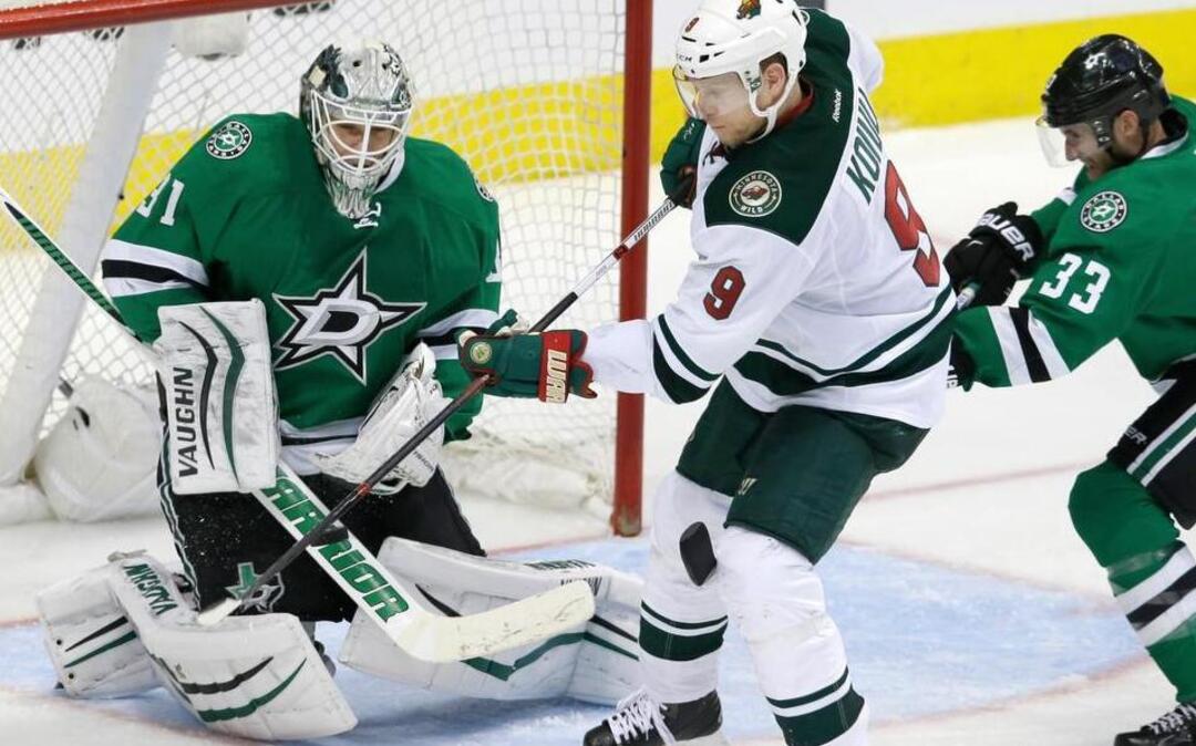 Minnesota Wild center Mikko Koivu (9) scores a goal against Dallas Stars goalie Antti Niemi (31) and defenseman Alex Goligoski (33) during overtime in Game 5 in the first round of the NHL Stanley Cup playoffs Friday, April 22, 2016, in Dallas. The Wild won 5-4.