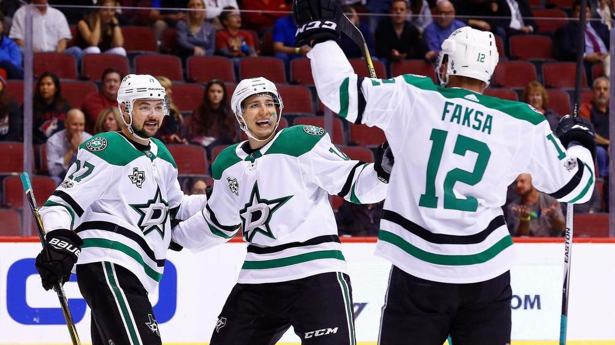 Dallas Stars center Radek Faksa (12) celebrates his goal against the Arizona Coyotes with Stars center Devin Shore (17) and Stars center Tyler Pitlick, middle, during the first period of Thursday’s game in Glendale, Ariz.