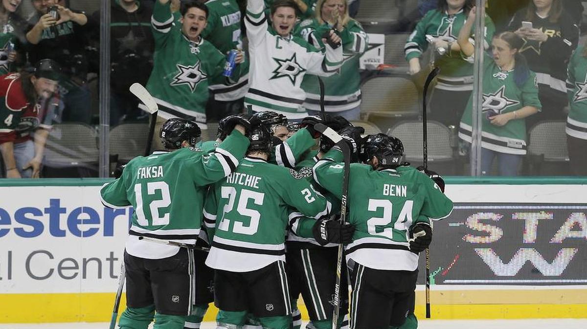 The Stars celebrate Jamie Benn’s winning goal in overtime Monday night against the Minnesota Wild.