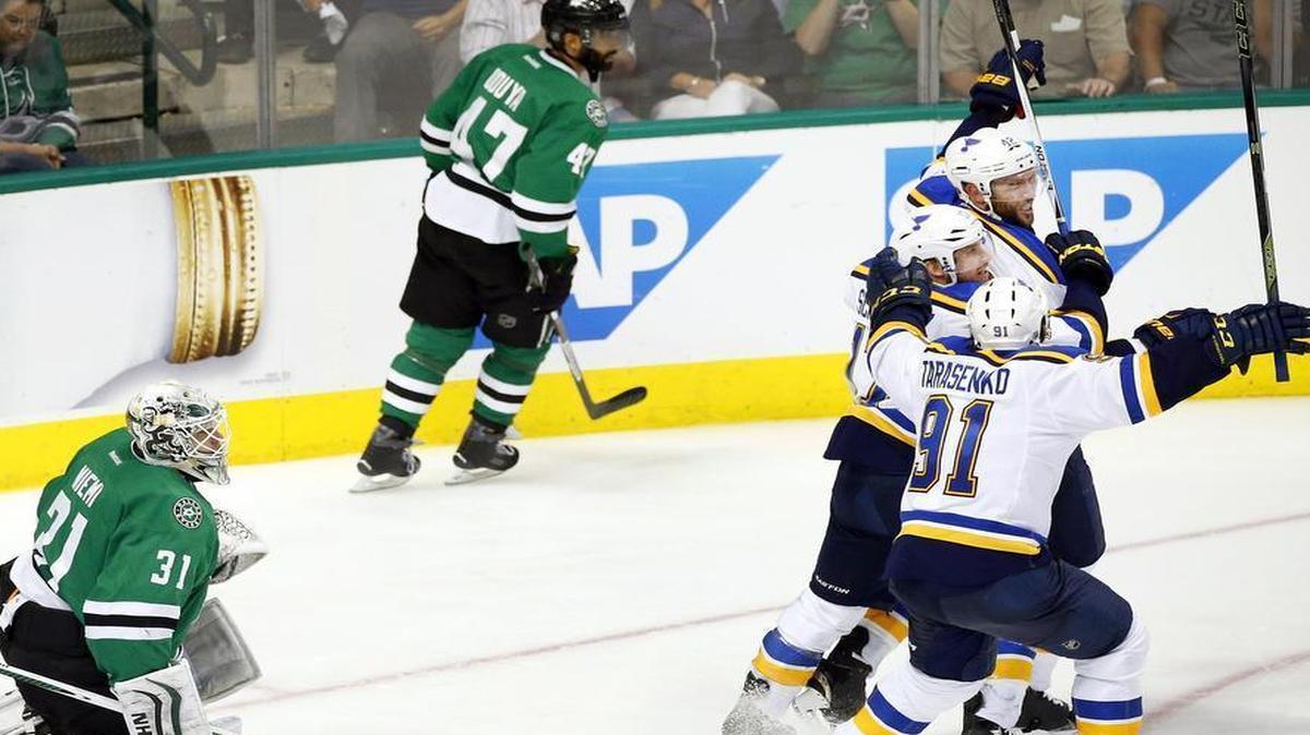 Dallas Stars goalie Antti Niemi (31) watches as St. Louis Blues center David Backes, top right, celebrates with teammates after he scored the goal in overtime to beat the Stars 4-3 Sunday at American Airlines Center in Dallas.