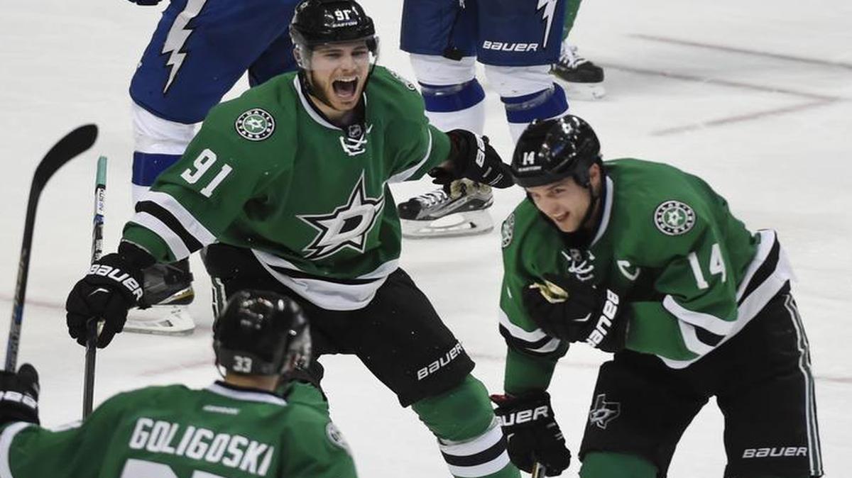 Stars left wing Jamie Benn (14) celebrates his game-winning goal with teammates Alex Goligoski (33) and Tyler Seguin (91) on Thursday night in Dallas.