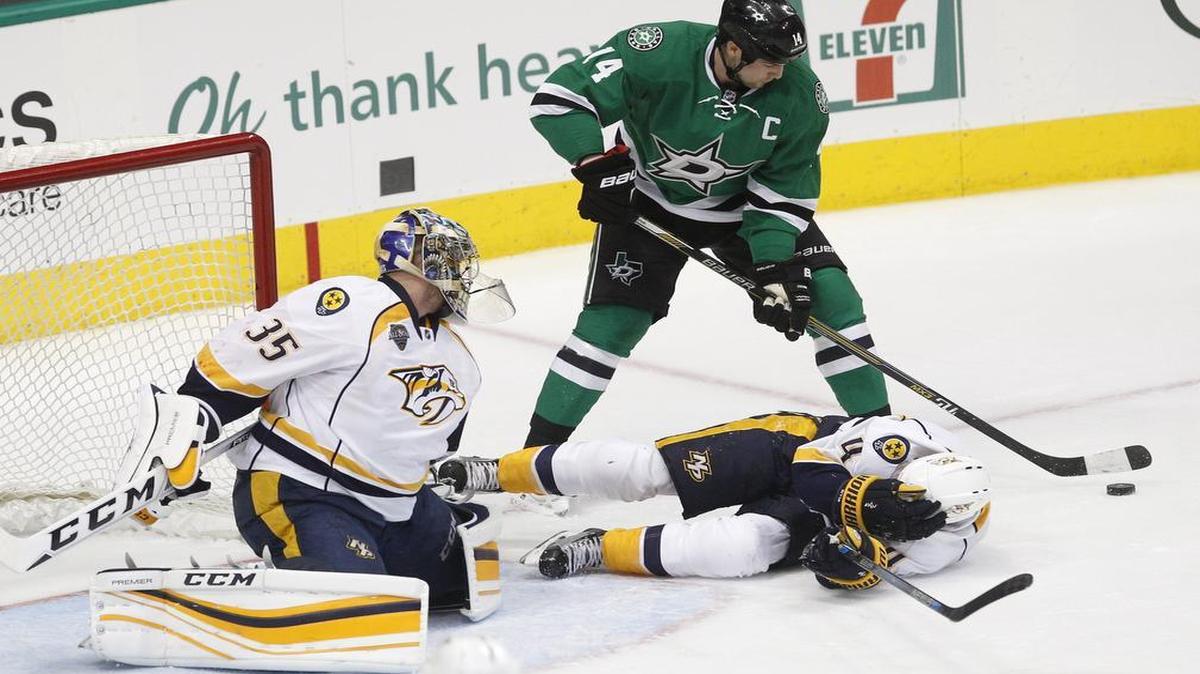 Stars left wing Jamie Benn (14) looks for the shot on Predators goalie Pekka Rinne (35) as defenseman Ryan Ellis (4) tries to avoid injury during the first period Tuesday.