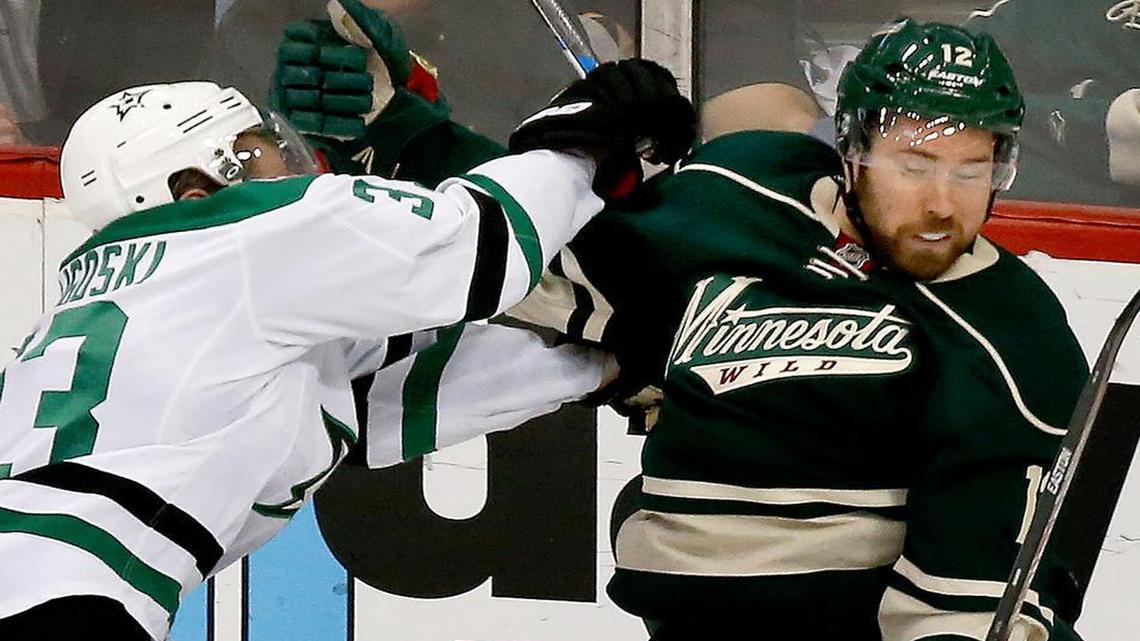 Dallas Stars’ Alex Goligoski (33) and Minnesota Wild’s David Jones (12) fight for position during the second period on Sunday, April 24, 2016, at Xcel Energy Center in St. Paul, Minn.