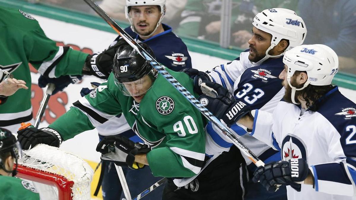 Stars center Jason Spezza (90) got caught in a second-period scuffle with Winnipeg defenseman Dustin Byfuglien (33) on Thursday. But Spezza suffered a rougher hit later and had to leave the game. Coach Lindy Ruff said he expects Spezza to miss some time, beginning with Saturday’s game against Chicago.