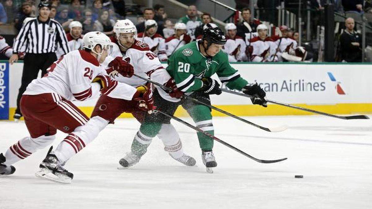 
Dallas Stars center Cody Eakin (20) tries to shoot in the first period as Arizona Coyotes left wing Lauri Korpikoski (28) and center Antoine Vermette (50) defend on Wednesday at American Airlines Center in Dallas. 
