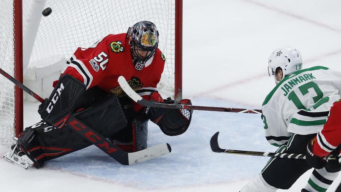 Dallas Stars’ Mattias Janmark, right, scores the game-winning goal on Chicago Blackhawks’ goalie Corey Crawford during overtime of Thursday’s game in Chicago. The Stars won 4-3.