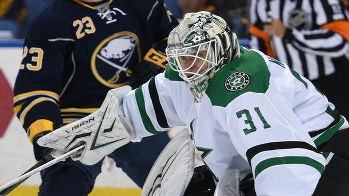 Stars goaltender Antti Niemi makes a makes a save in front of Sabres center Sam Reinhart in the first period Tuesday.