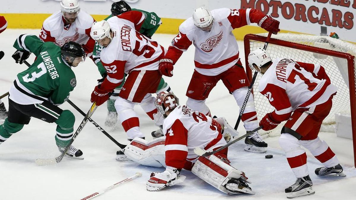 Dallas Stars defenseman John Klingberg, left, takes on seemingly the entire Red Wings team and scores one of the Stars’ three second-period goals in Thursday’s 5-2 victory.