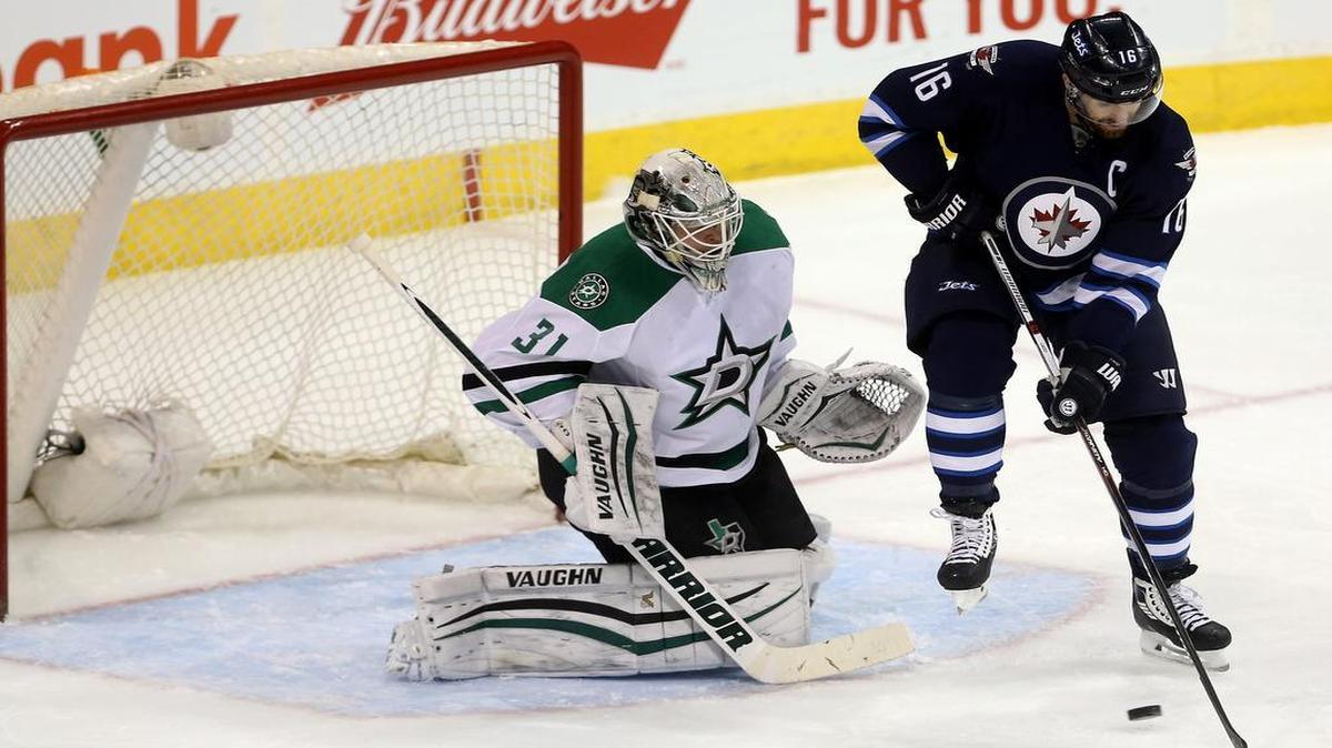 Winnipeg captain Andrew Ladd, right, tries to deflect a shot past Stars goaltender Antti Niemi in the first period Tuesday. The Stars head into Thursday’s rematch with a 7-3-1 record since the All-Star break. Their 15 points during that span are tied for third-most in the league.