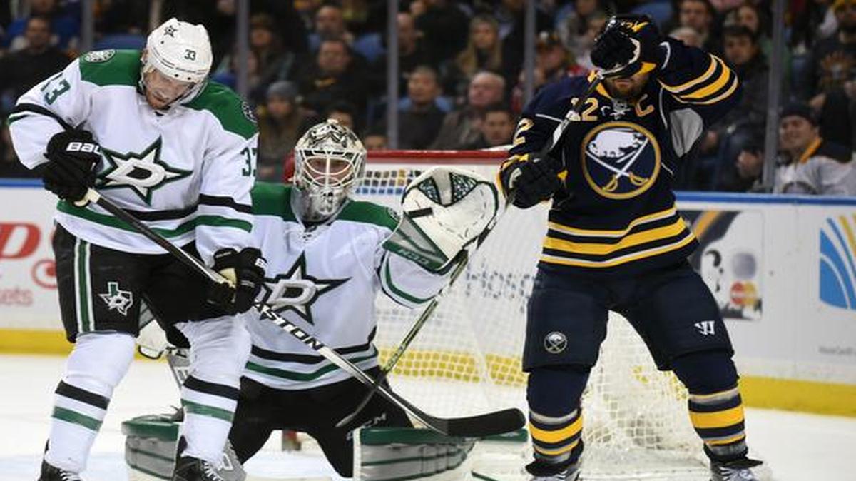 
Dallas Stars defenseman Alex Goligoski (33) and Buffalo Sabres right winger Brian Gionta (12) flinch on the high shot as Stars goaltender Anders Lindback keeps an eye on the puck Saturday. Lindback was making his first start since Jan. 15 as Dallas played the first game of a back-to-back. 
