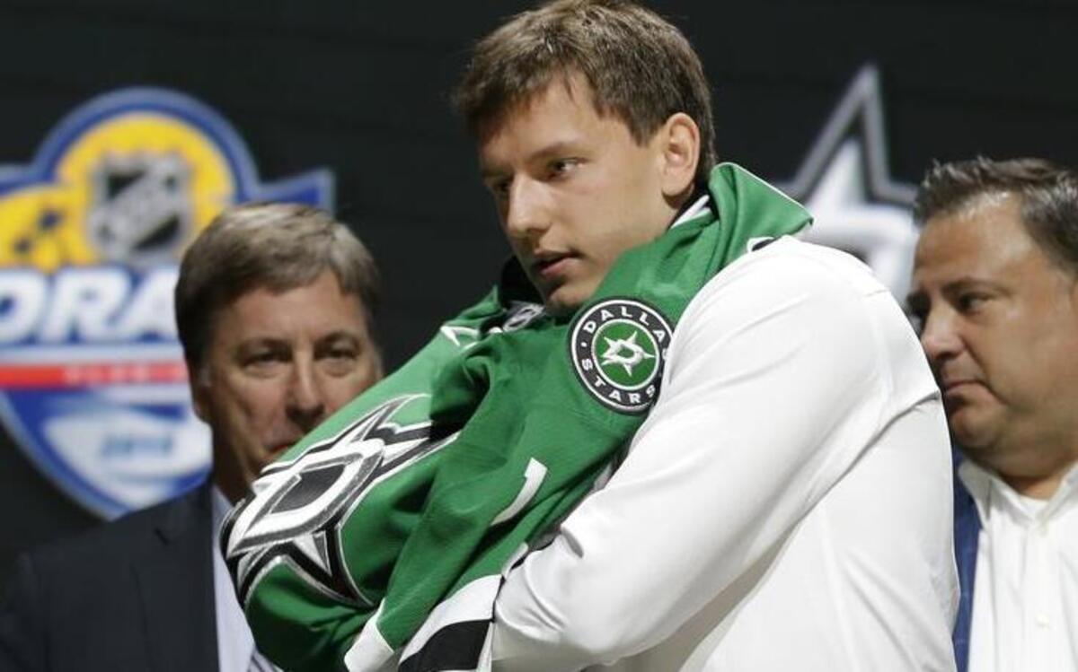 
Denis Gurianov, a 6-foot-3, 190-pounder from Russia, puts on a Stars sweater after being picked 12th overall.

