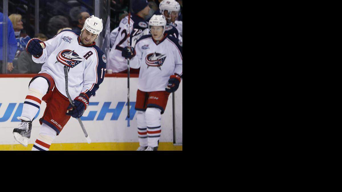 
Columbus Blue Jackets center Brandon Dubinsky, front, celebrates his first goal of the season Sunday in Denver. Dubinsky missed the first 26 games of the season after abdominal surgery.


