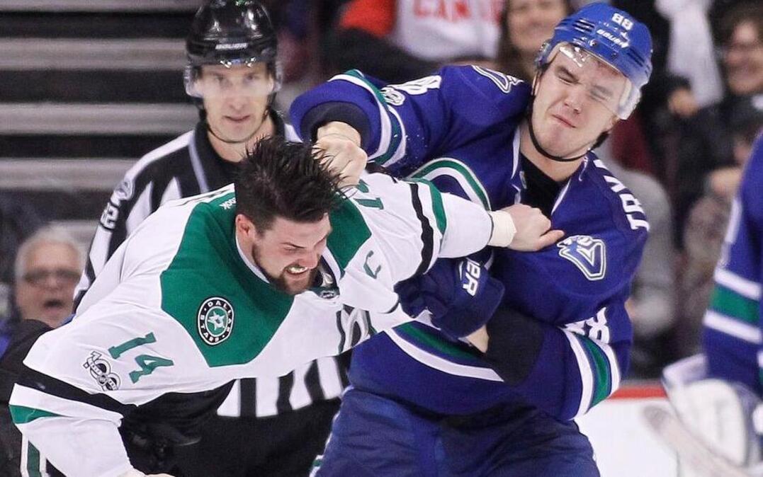 Dallas Stars’ Jamie Benn (14) fights Vancouver Canucks’ Nikita Tryamkin (88) during the second period of an NHL hockey game Thursday, March 16, 2017, in Vancouver, British Columbia.
